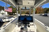 2026 Cobia 265 Center Console boat dashboard with steering wheel and American flag.
