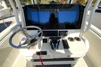 2026 Cobia 265 Center Console boat dashboard with steering wheel and dual screens.