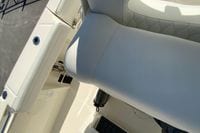 2026 Cobia 265 Center Console boat interior with white seating and storage compartments.