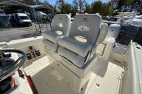 2026 Cobia 265 Center Console boat with dual cushioned seats and steering wheel.