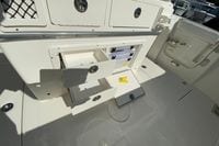 2026 Cobia 265 Center Console boat storage compartments with open drawers and tackle storage.