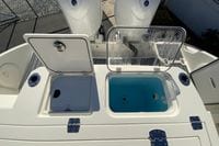 2026 Cobia 265 Center Console boat with open storage compartments.