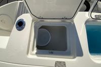 2026 Cobia 265 Center Console boat storage compartment with open lid.
