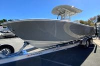 2026 Cobia 265 Center Console boat on trailer under clear blue sky.