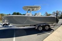 2026 Cobia 265 Center Console boat on trailer in parking lot.