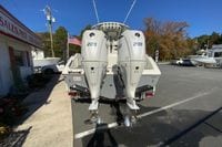 2026 Cobia 265 Center Console boat with dual 200 horsepower engines, parked outdoors.