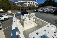 2026 Cobia 265 Center Console boat at dealership, showcasing spacious deck and seating.