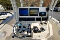 2019 Cobia 262 Center Console boat dashboard with steering wheel and navigation screens.