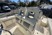 2019 Cobia 262 Center Console boat with dual cushioned seats, docked outdoors.