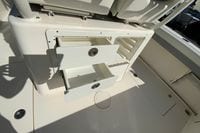 2019 Cobia 262 Center Console boat with open storage drawers.