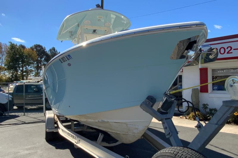 2019 Cobia 262 Center Console boat on trailer, parked outdoors.