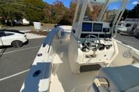 2019 Cobia 262 Center Console boat with modern dashboard and steering, parked outdoors.