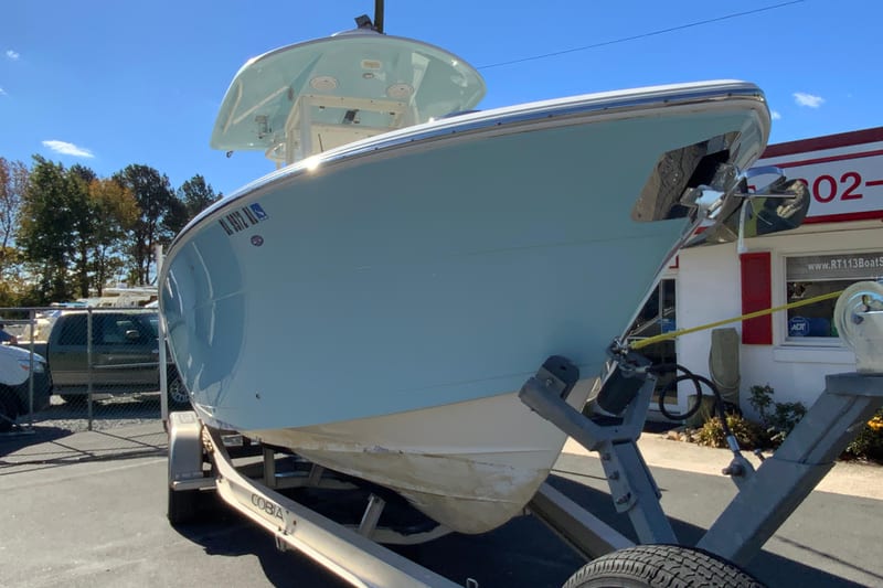 2019 Cobia 262 Center Console boat on trailer, parked outdoors.