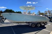 2019 Cobia 262 Center Console boat on trailer under clear blue sky.
