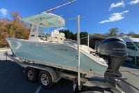2019 Cobia 262 Center Console boat on trailer with Yamaha engine, under clear blue sky.