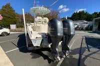 2019 Cobia 262 Center Console boat with dual Yamaha 150 engines in a sales lot.