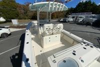 2019 Cobia 262 Center Console boat in a dealership lot, showcasing seating and console features.