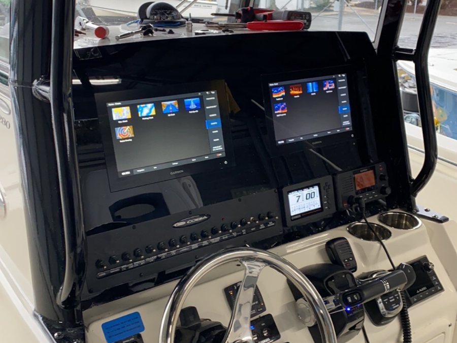 A Cobia helm with twin Garmin displays, VHF and stereo rigged in our shop