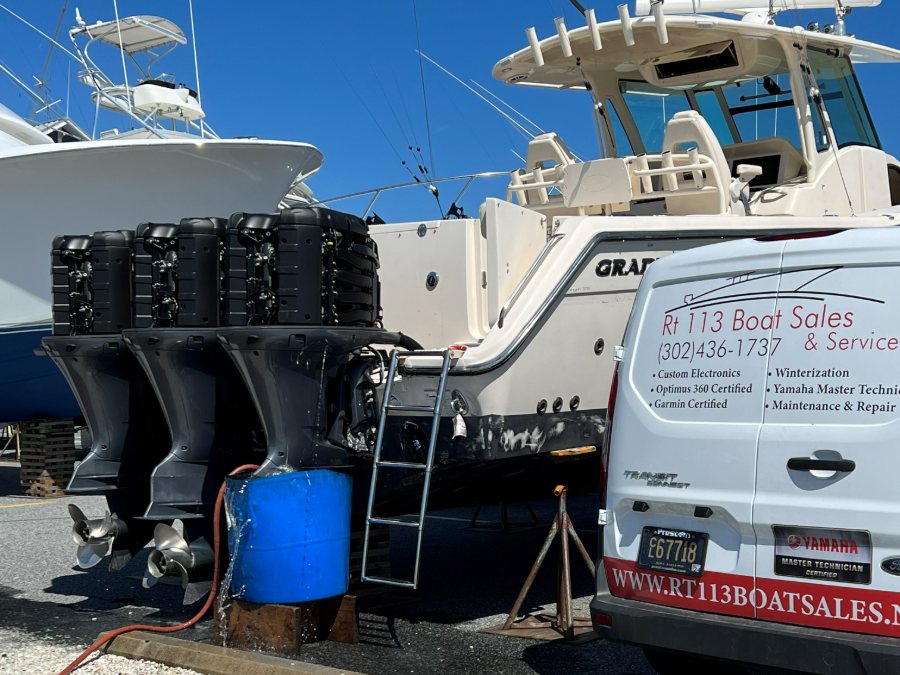 The RT 113 mobile service van alongside a customer boat, triple outboards off the transom